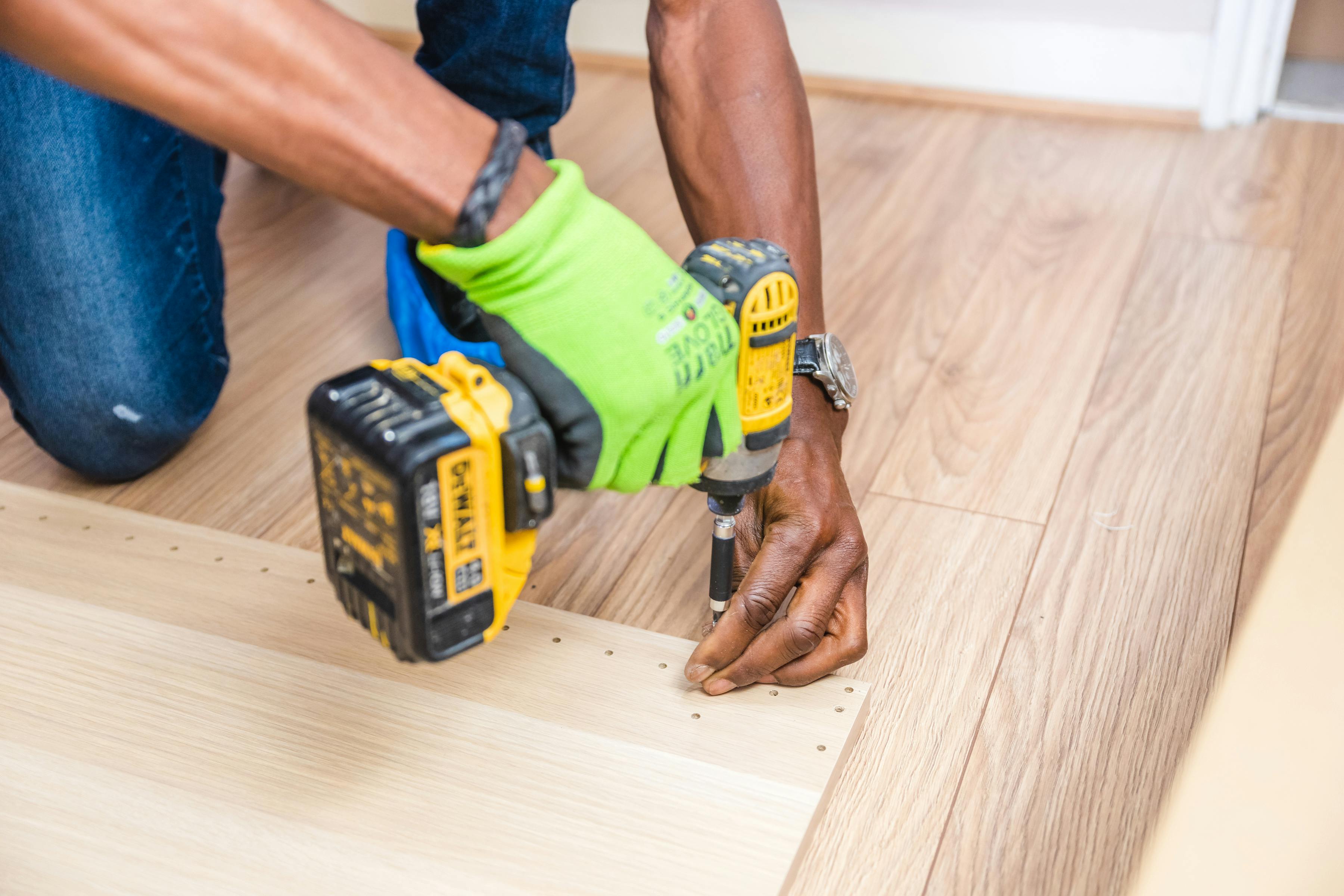 Close-up detail of a handyman using a drill on interior finish work