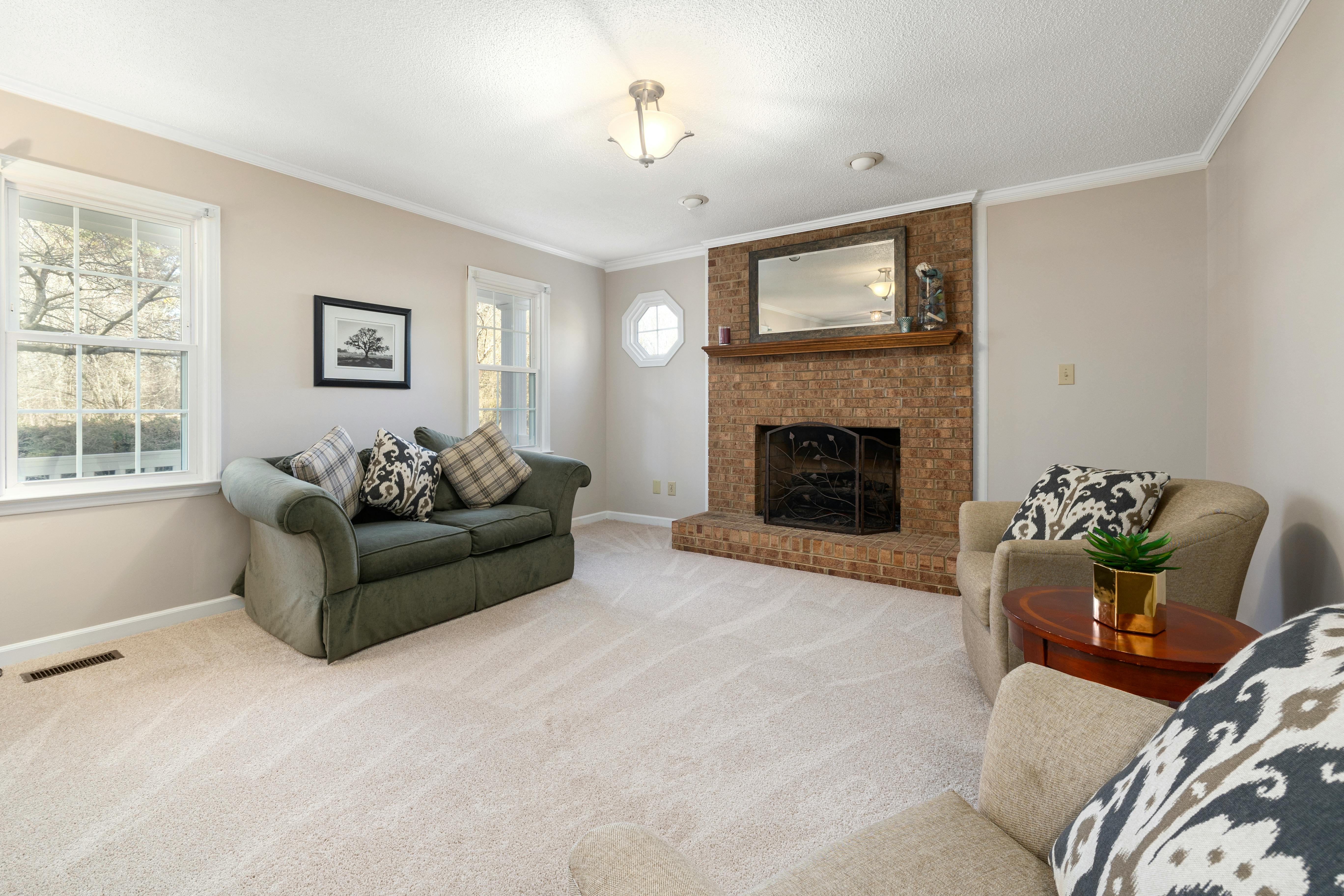 Finished living room with fireplace, built-ins, and refined trim details